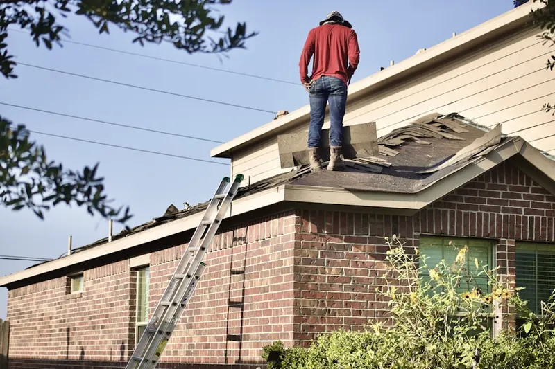 Professional roofer working on a residential roof in Forestbrooke